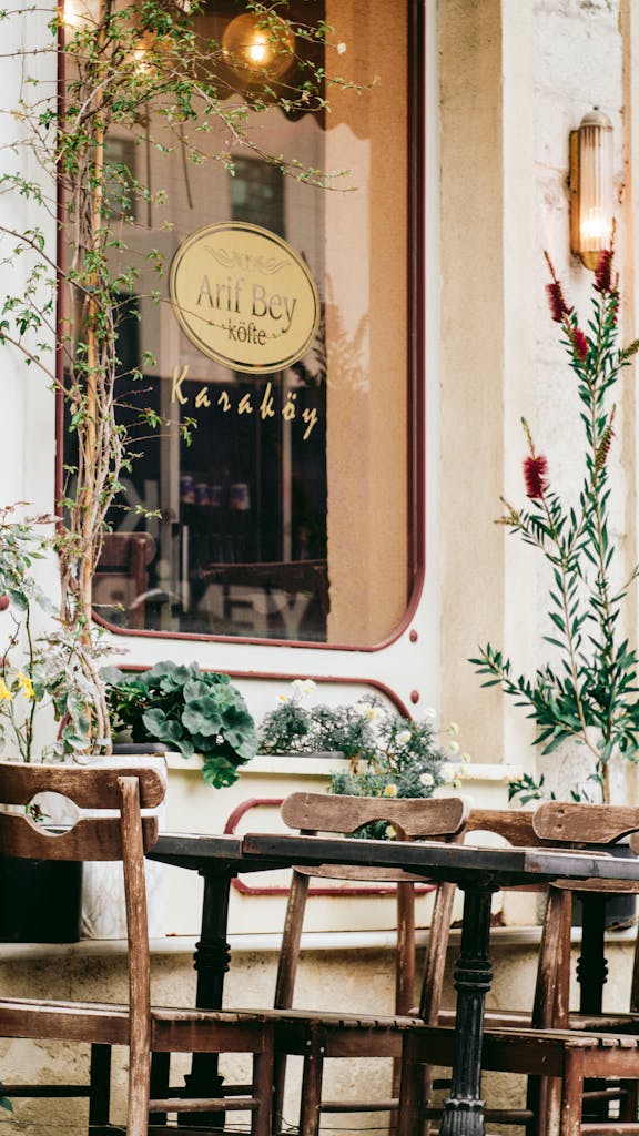 Inviting street view of a cozy café with wooden chairs in Karaköy, İstanbul.